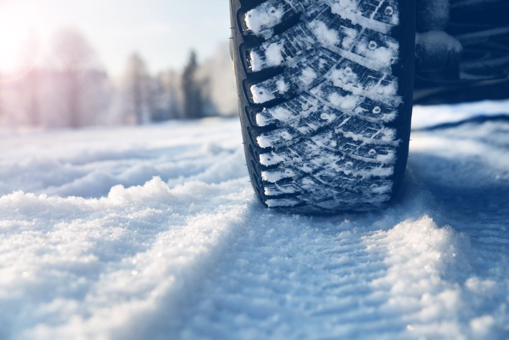 Closeup,of,car,tires,in,winter,on,the,road,covered