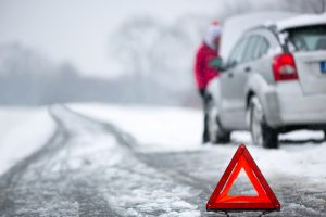 Warning,triangle,with,winter,car,breakdown,in,background